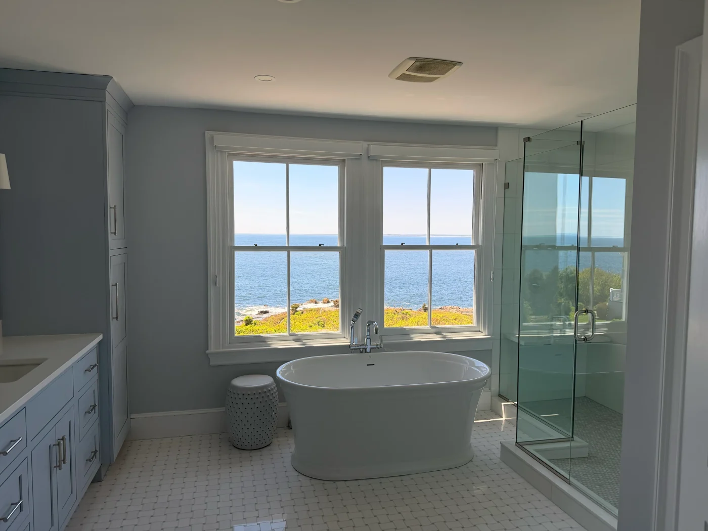 An oceanfront bathroom with freshly cleaned windows looking out to the Atlantic
